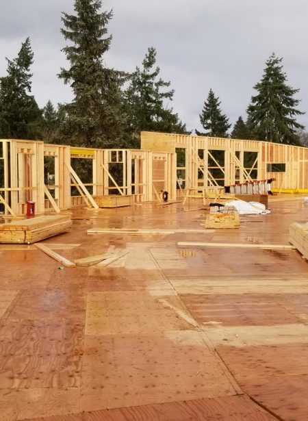 Framing exterior of apartment building construction project on Vancouver Island, BC
